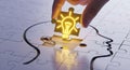 Idea Solution Creativity Puzzle Concept: Hand Placing Glowing Light Bulb in Brain Outline on White Background Royalty Free Stock Photo
