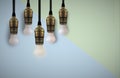 Idea concept with light bulb or Hanging light bulbs with glowing one different idea Royalty Free Stock Photo