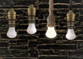 Idea concept with light bulb or Hanging light bulbs with glowing one different idea Royalty Free Stock Photo