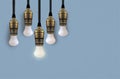 Idea concept with light bulb or Hanging light bulbs with glowing one different idea Royalty Free Stock Photo