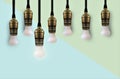 Idea concept with light bulb or Hanging light bulbs with glowing one different idea Royalty Free Stock Photo