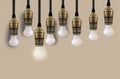 Idea concept with light bulb or Hanging light bulbs with glowing one different idea Royalty Free Stock Photo