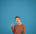 Idea Concept. Pensive Preteen Boy Pointing Finger And Looking Up Royalty Free Stock Photo