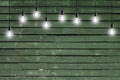 Idea concept - Vintage incandescent bulbs on wooden wall Royalty Free Stock Photo