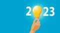 Idea and creative in 2023 lighting bulb with new year 2023 number on blue background Royalty Free Stock Photo