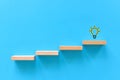 idea, creativity, success. wooden blocks create a staircase with a light bulb on top. Royalty Free Stock Photo
