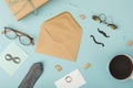 An idea for a Father's Day surprise. A top view vertical of an open envelope, a postcard with mustaches, a