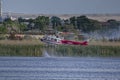 A Fire Fighting Helicopter Coming In To Fill Water Tanks To Continue Fighting Wildfire