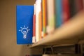 An idea icon on book in a bookshelf Royalty Free Stock Photo