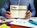 Idea Implementation plan in the small notepad Royalty Free Stock Photo