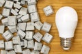 LED light bulb and pile of computer keyboard keys Royalty Free Stock Photo