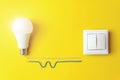 Idea, innovation, creativity concept with glowing light bulb and switch with wires phase, zero on Yellow Background. Power energy Royalty Free Stock Photo