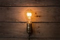 Idea and leadership business concept, vintage incandescent light bulb on the wooden background Royalty Free Stock Photo