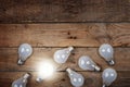 Vintage bulbs on wooden background - idea, innovation, teamwork and leadership concept. Space for text Royalty Free Stock Photo