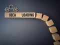 Idea loading text with wooden blocks in progress bar background.
