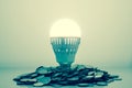 Idea is money concept, Light bulb bright on money coins pile Royalty Free Stock Photo