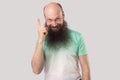 Idea. Portrait of excited middle aged bald man with long beard in t-shirt standing, holding his finger up in idea gesture and