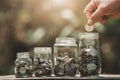 Idea saving money hand putting coins in to jug glass. finance accounting Royalty Free Stock Photo