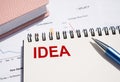 IDEA text written on notepad with pen on financial documents Royalty Free Stock Photo