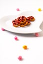 Idea for Valentine treats pretzel dip chocolate in ceramic heart shape plate on white background with copy space