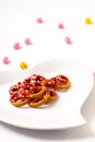 Idea for Valentine treats pretzel dip chocolate in ceramic heart shape plate on white background with copy space