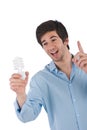 Idea - Young man holding energy saving light bulb