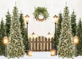 Custom christmas decoration in white brick wall with beautiful pine trees, lamp posts, garlands and snow, for studio photography