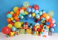 Personalized ABC toy decor with colorful balloon arch, and lights for the first birthday