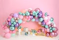 Personalized romantic decorations, backdrop, background with colorful spring flowers, balloons, lights for the first birthday