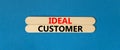 Ideal customer symbol. Concept words Ideal customer on beautiful wooden stick. Beautiful blue table blue background. Business Royalty Free Stock Photo