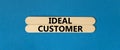 Ideal customer symbol. Concept words Ideal customer on beautiful wooden stick. Beautiful blue table blue background. Business Royalty Free Stock Photo