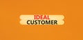 Ideal customer symbol. Concept words Ideal customer on beautiful wooden stick. Beautiful orange table orange background. Business Royalty Free Stock Photo