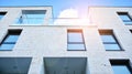 Image of condo on afternoon with sun set. Contemporary white residential building against a blue sky. Royalty Free Stock Photo