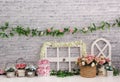 Delicate personalized romantic decor in brick, with colorful spring flower vases, and first birthday door