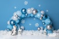 Personalized decoration with colorful balloon arch, with snowman, and snow for the first birthday