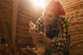 Happy chicken farmer woman showing a young small chicken in her hands in a henhouse Royalty Free Stock Photo
