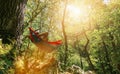 Man relaxing in the hammock hanging among the trees in the forest Royalty Free Stock Photo