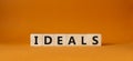 Ideals symbol. Wooden blocks with word Ideals. Beautiful orange background. Business and Ideals concept. Copy space