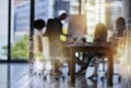 Ideas that build cities. Shot of a team of brainstorming businesspeople double exposed with an image of a city. Royalty Free Stock Photo