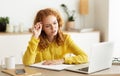 Ideas for business. Pensive woman making notes using laptop Royalty Free Stock Photo