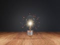 Ideas that illuminate with Light bulb on Wood table top Royalty Free Stock Photo