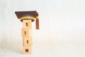 Ideas for STEM Education about science, technology, engineering, mathematics word on Graduation celebrating cap with wooden blocks