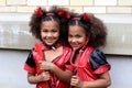 Identical African-American girl twins disguised as devils