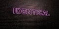 IDENTICAL -Realistic Neon Sign on Brick Wall background - 3D rendered royalty free stock image