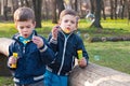 Identical twin brothers blow soap bubbles