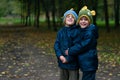 Identical twin brothers embraced with mock expression