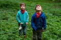 Identical twin brothers in forest thickets
