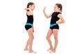 Identical twin girls practice and doing rhythmic gymnastics, white background Royalty Free Stock Photo