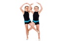 Identical twin girls practice and doing rhythmic gymnastics, white background Royalty Free Stock Photo