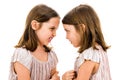 Identical twin girls sisters are arguing yelling at each other Royalty Free Stock Photo